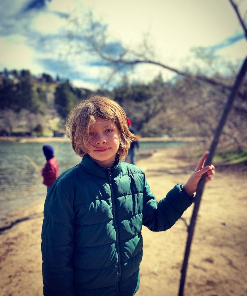 Luca playing at a lake beach